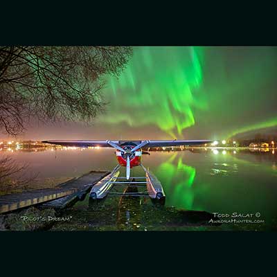  October 13, 2012 at 12:15 am. Lake Hood Seaplane Base, Anchorage. Cessna 195. Waves of auroras reflect on calm water.